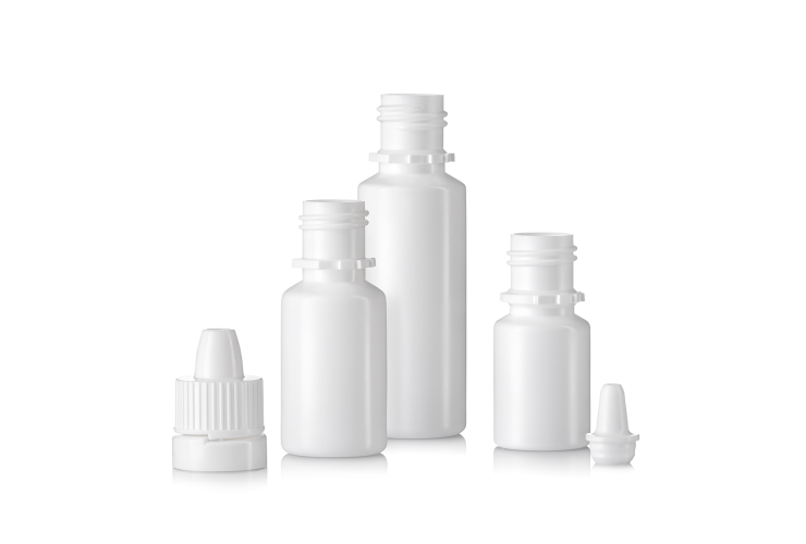 Four white ALPLApharma ophthalmic plastic bottles, closures and nozzle in varying sizes