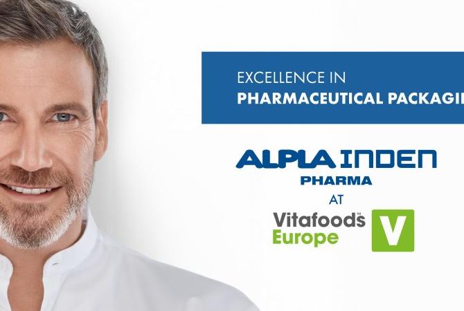 Man holding pharmaceutical packaging with Vitafoods fair details on the right side
